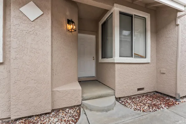 a front view of a house with a garden and yard