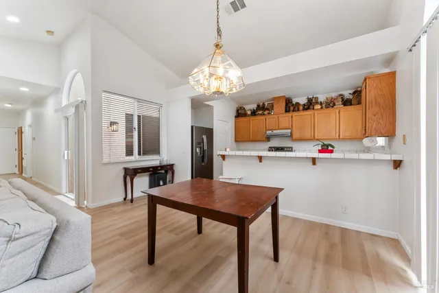 a kitchen with stainless steel appliances granite countertop a stove refrigerator and microwave