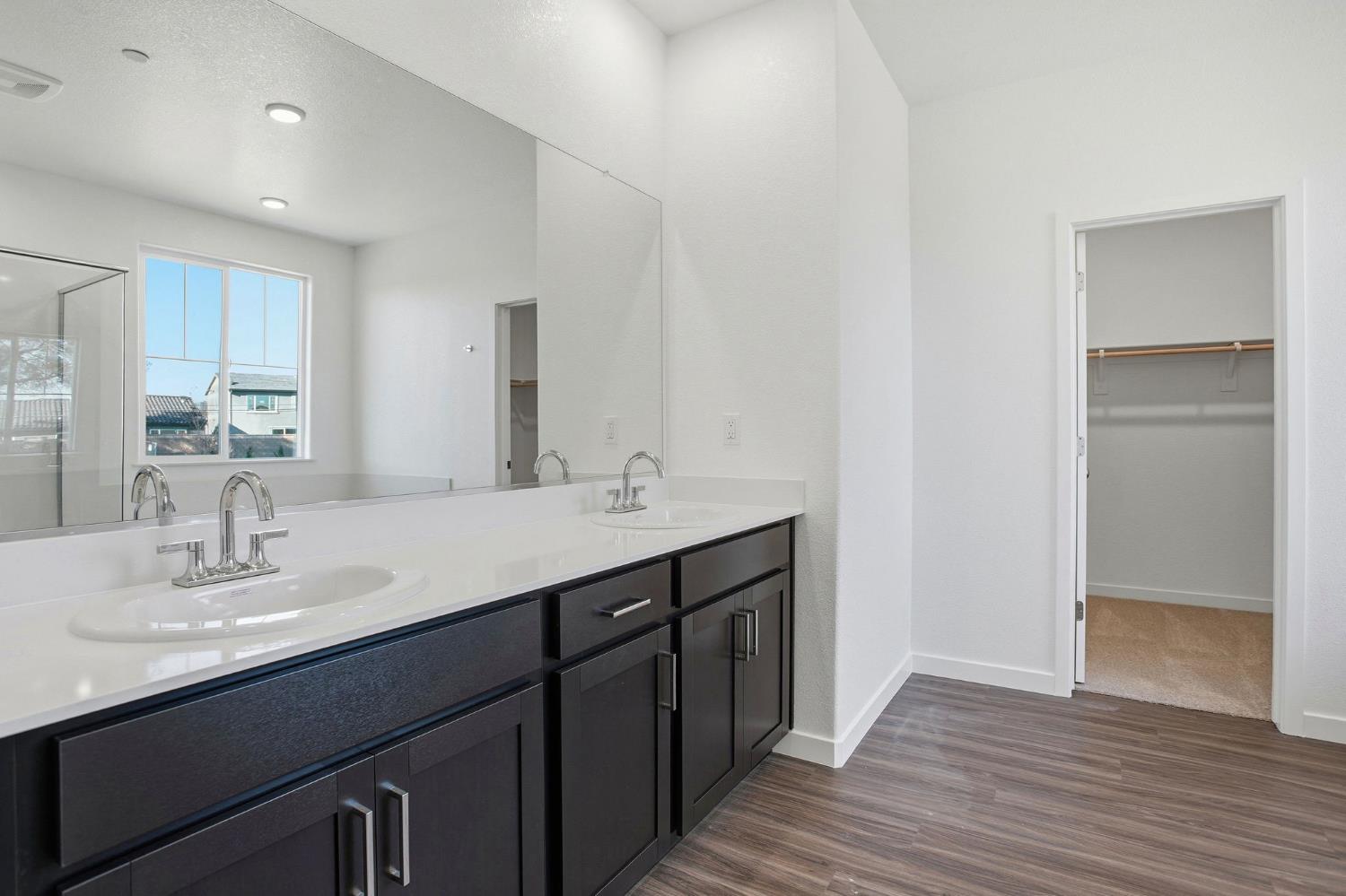 1031 Slalom Way Lincoln, CA 95648 - Photo 7 of 12 a bathroom with a double vanity sink and a mirror