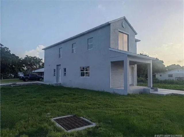 a backyard of a house with lots of green space and plants