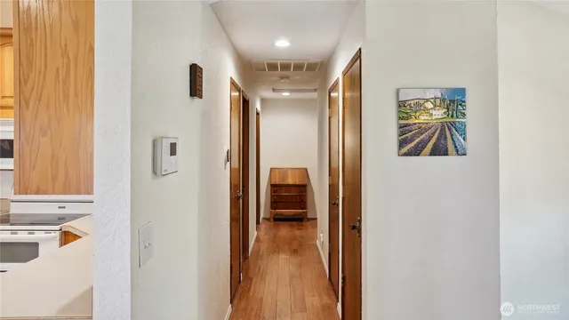 a view of hallway with furniture and a window