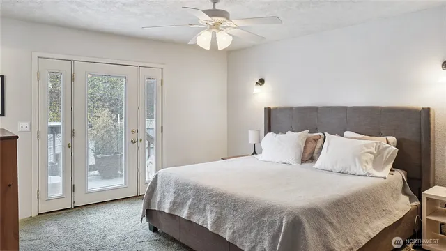 a bedroom with a large bed and a chandelier