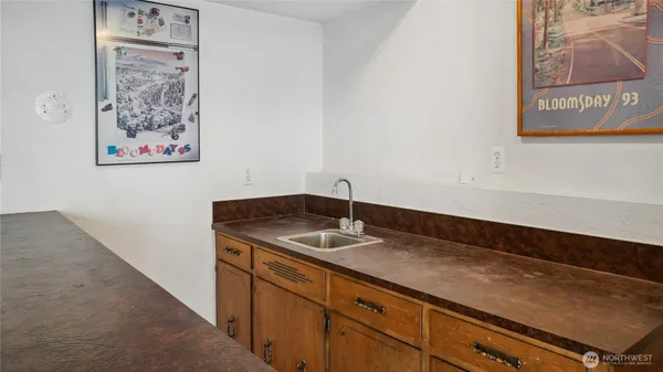 a view of a refrigerator a sink and a stove in a kitchen