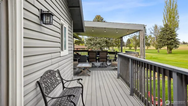 a view of balcony with chairs and wooden fence