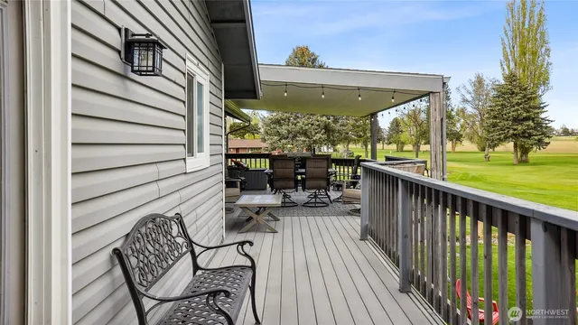 a view of balcony with chairs and wooden fence
