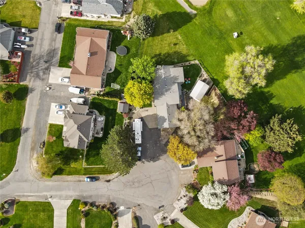 an aerial view of a house with a yard