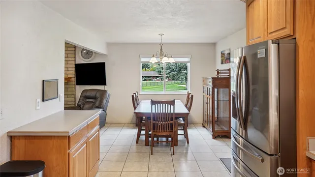 a dining room with furniture a chandelier and window
