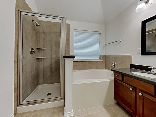 a bathroom with a shower and a sink