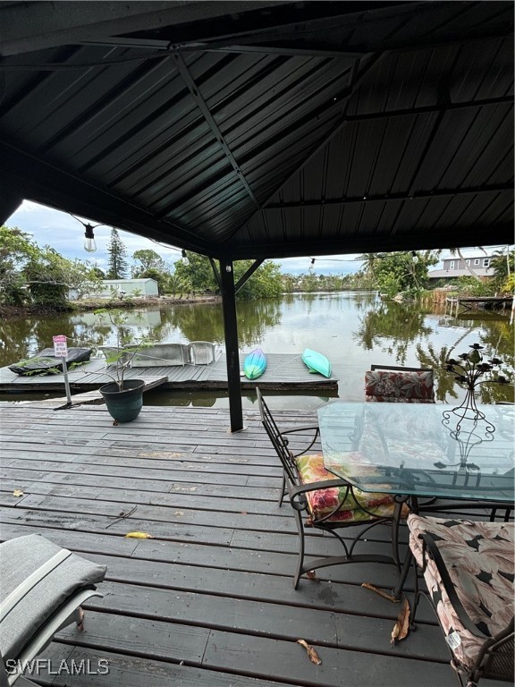 3048 Lunar Street Naples, FL 34112 - Photo 14 of 19 a view of a balcony with chairs and wooden floor