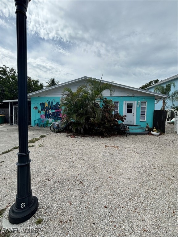 3048 Lunar Street Naples, FL 34112 - Photo 3 of 19 a front view of a house with garden