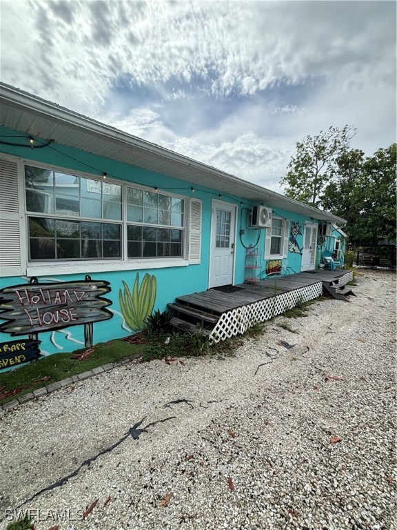 3048 Lunar Street Naples, FL 34112 - Photo 4 of 19 a front view of a house with a yard and potted plants