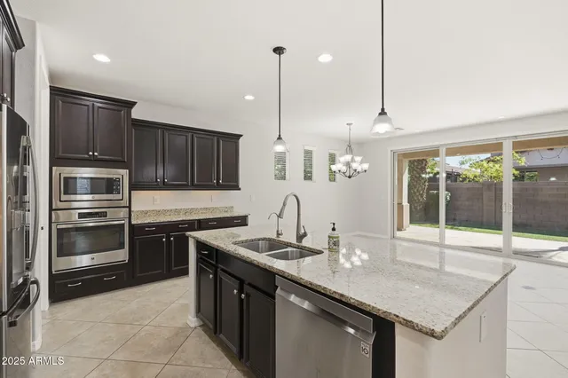 a kitchen with granite countertop stainless steel appliances and wooden cabinets