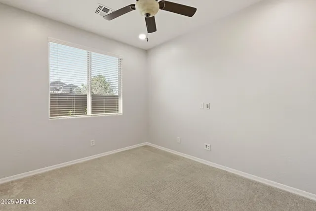 an empty room with closet and windows