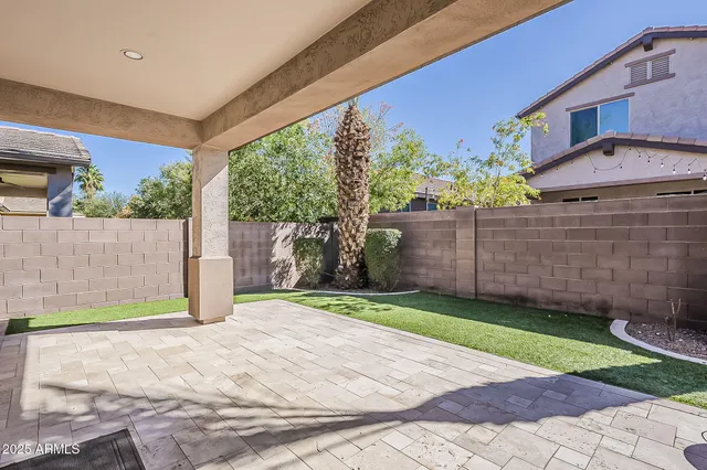 a front view of a house with a garden and yard