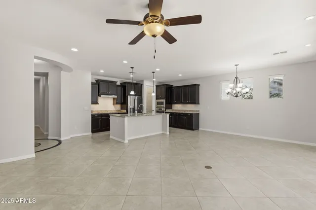 a view of a kitchen with a sink stainless steel appliances and cabinets
