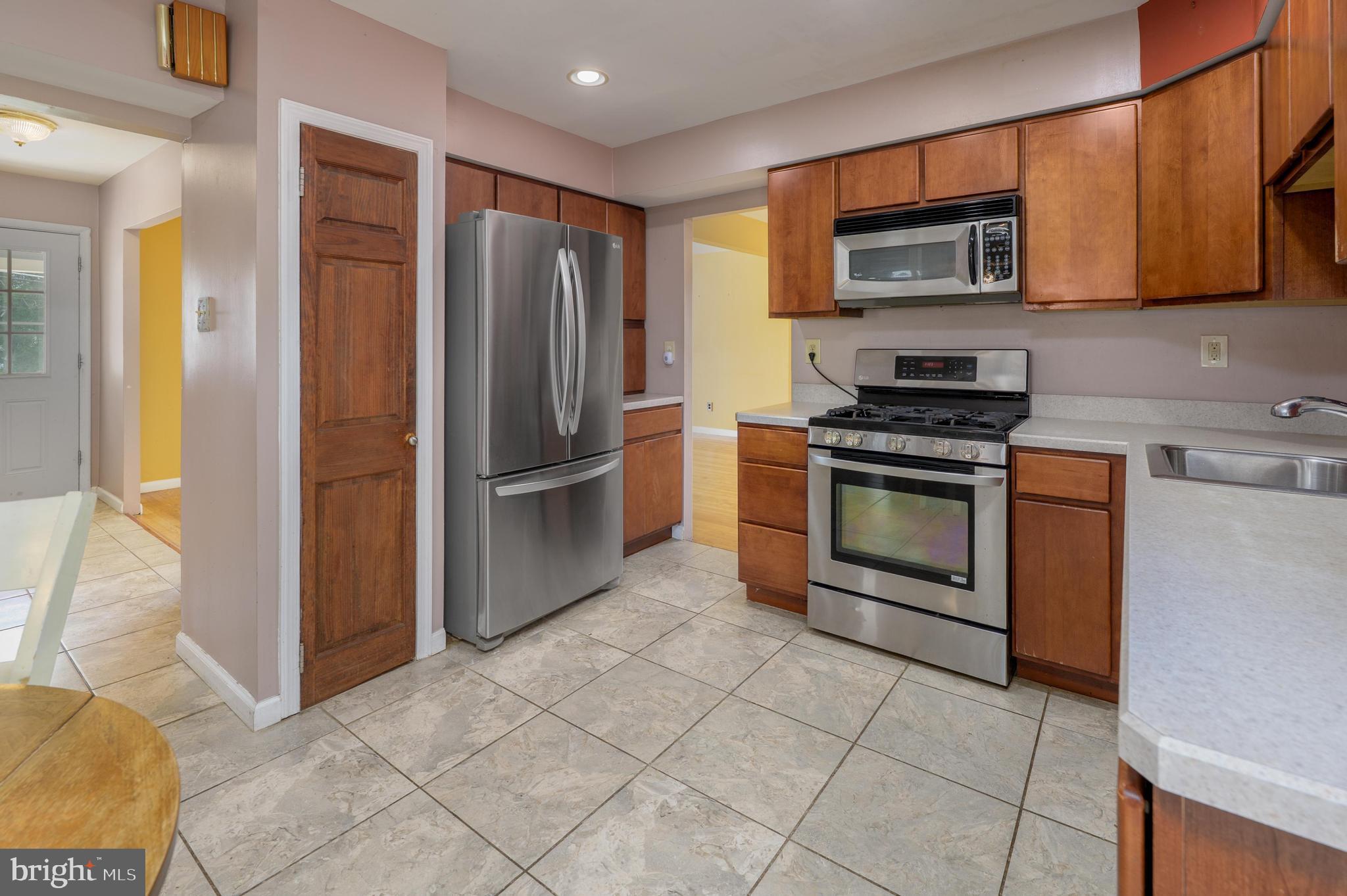 22 Clemson Road Cherry Hill, NJ 08034 - Photo 14 of 41 a kitchen with granite countertop a refrigerator and a stove top oven