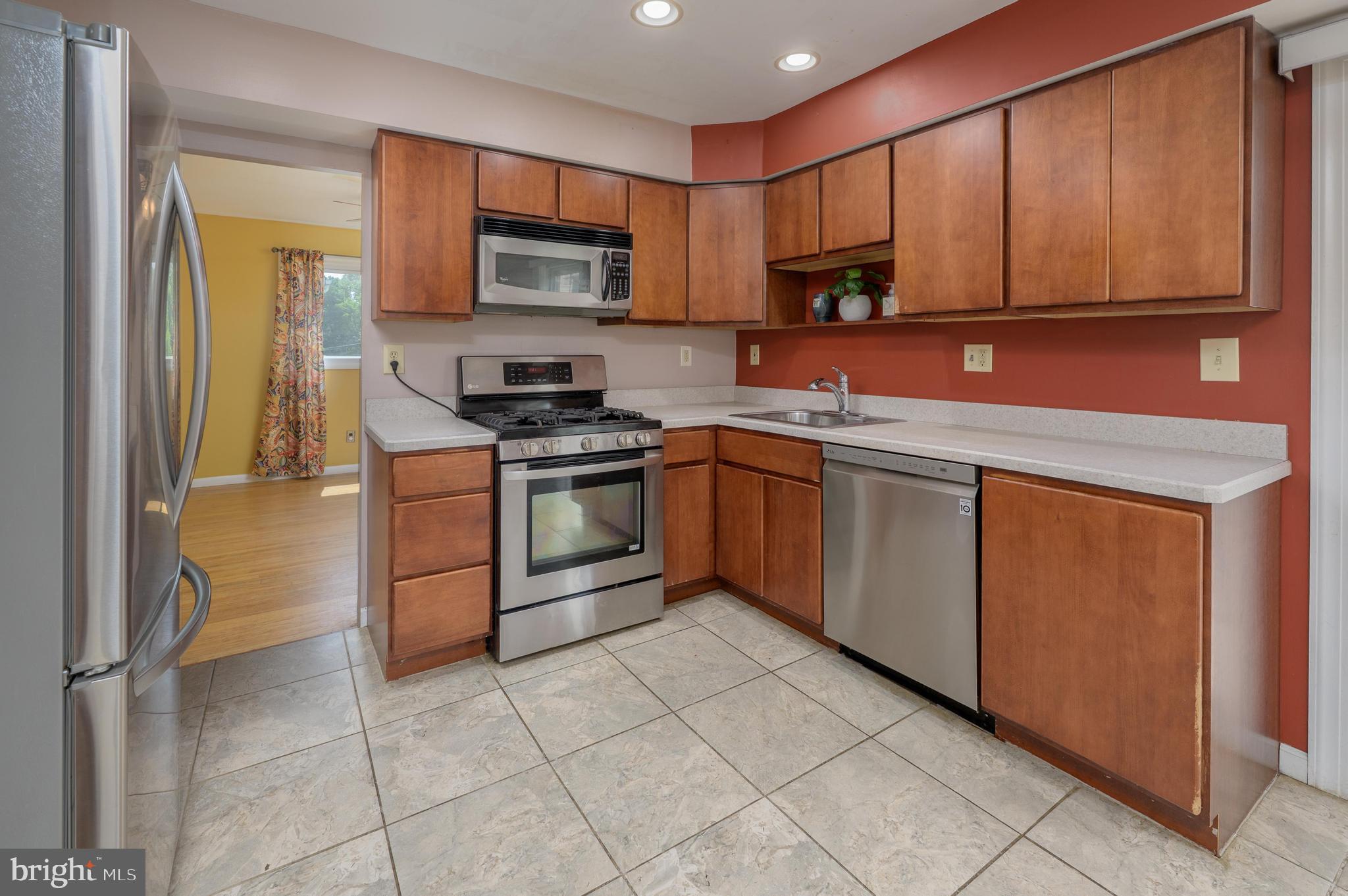 22 Clemson Road Cherry Hill, NJ 08034 - Photo 15 of 41 a kitchen with stainless steel appliances granite countertop a stove top oven a sink and dishwasher