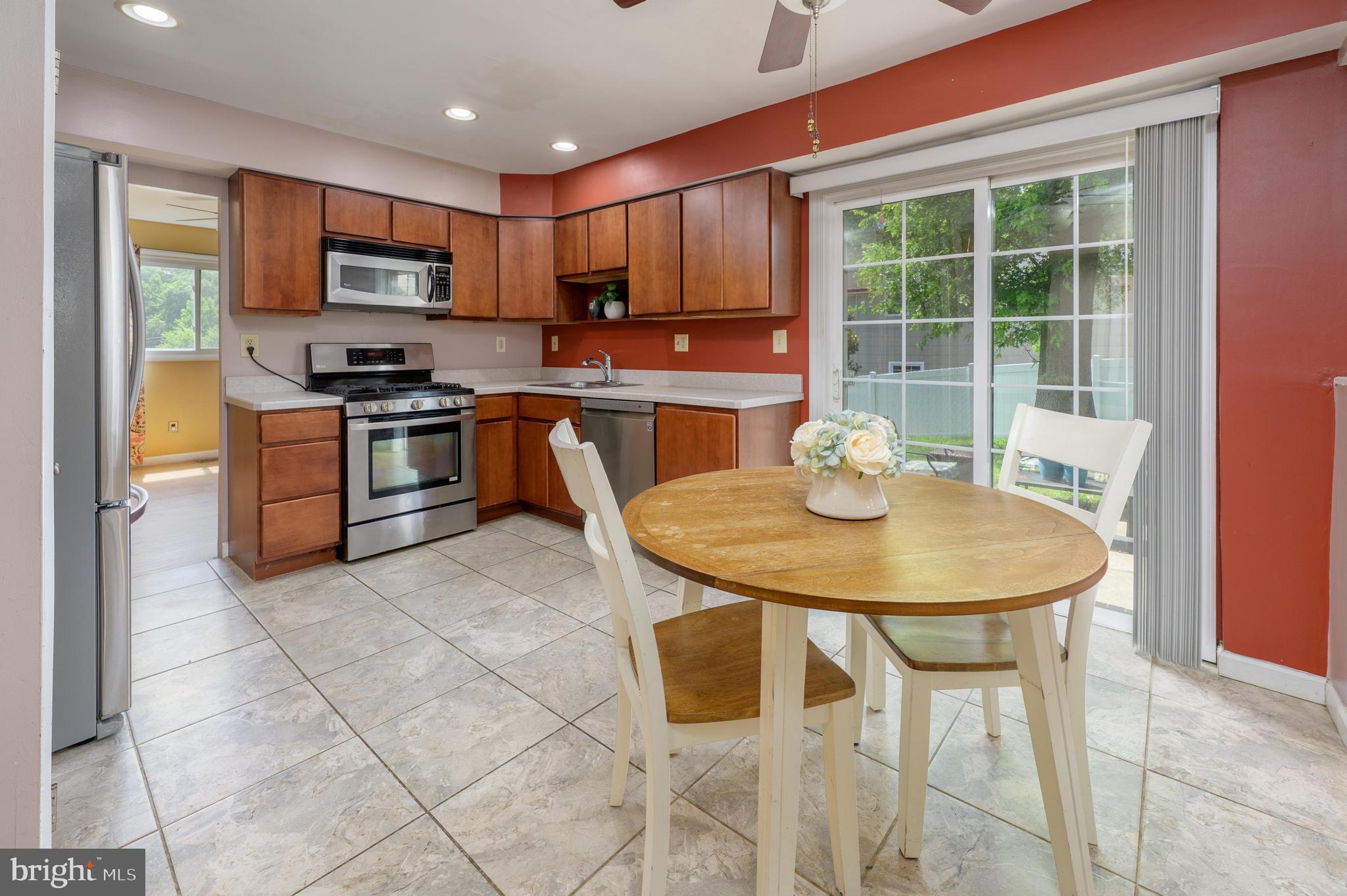 22 Clemson Road Cherry Hill, NJ 08034 - Photo 16 of 41 a kitchen with stainless steel appliances granite countertop a stove a sink a microwave a dining table and chairs