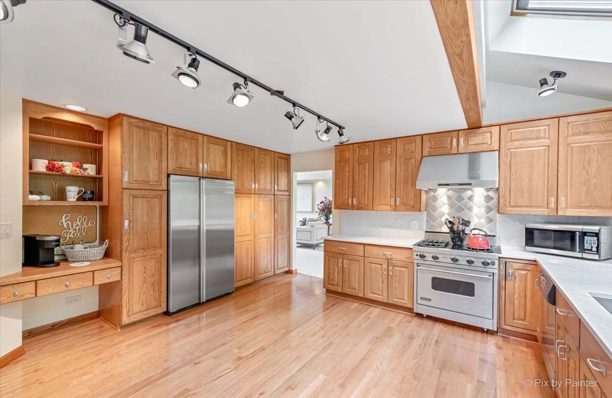 245 Perth Road Cary, IL 60013 - Photo 13 of 61 a kitchen with stainless steel appliances a refrigerator a sink and wooden floors