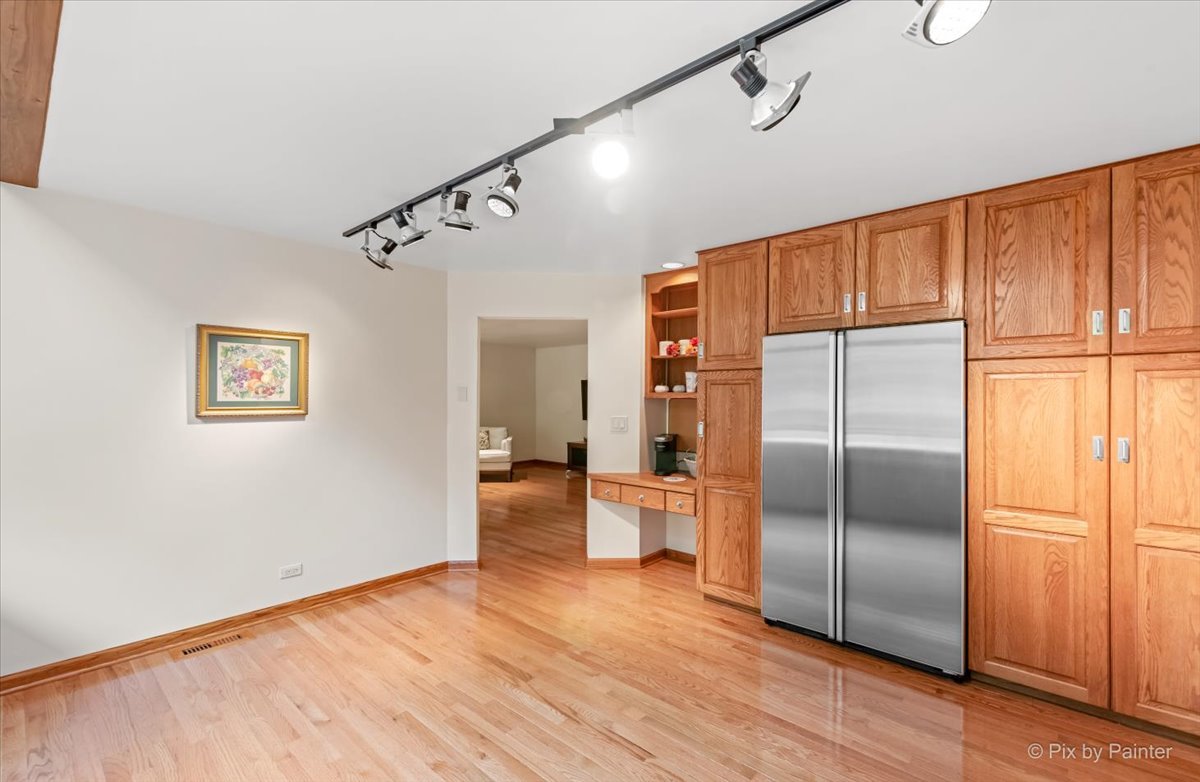 245 Perth Road Cary, IL 60013 - Photo 16 of 61 a kitchen with granite countertop stainless steel appliances a refrigerator and wooden floor