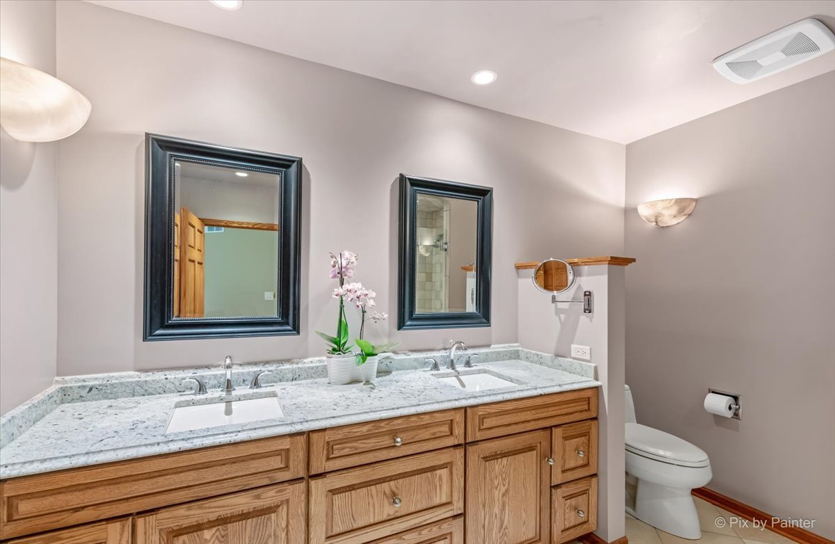 245 Perth Road Cary, IL 60013 - Photo 21 of 61 a bathroom with a granite countertop sink mirror and toilet