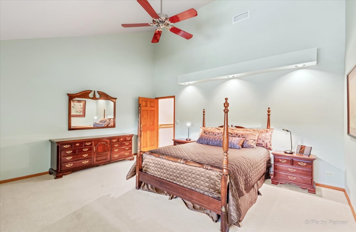 245 Perth Road Cary, IL 60013 - Photo 27 of 61 a bedroom with a bed and dresser with mirror