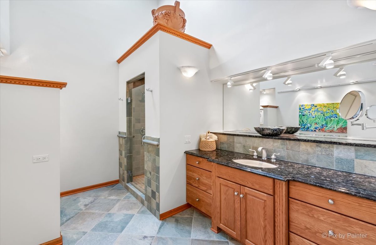 245 Perth Road Cary, IL 60013 - Photo 29 of 61 a bathroom with a granite countertop sink and a mirror