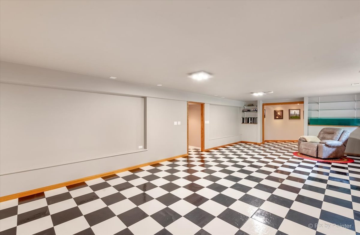 245 Perth Road Cary, IL 60013 - Photo 41 of 61 a bedroom with a bed and a black white checkered floor