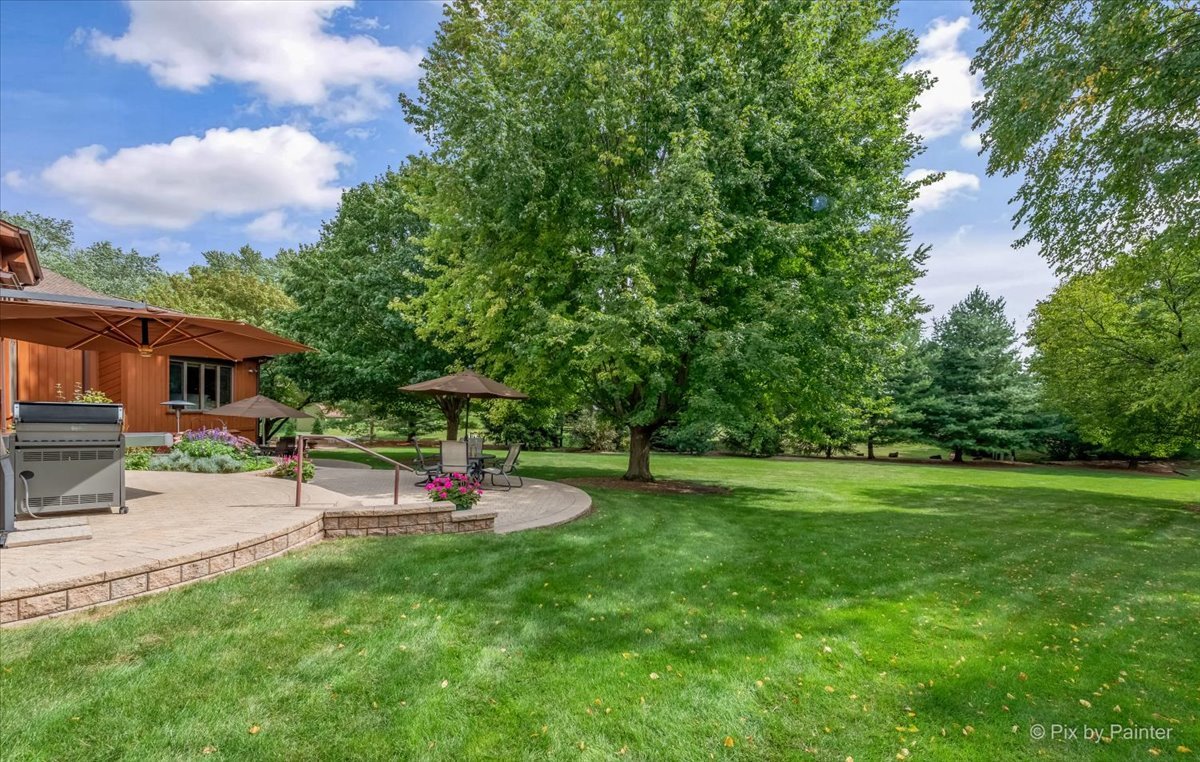 245 Perth Road Cary, IL 60013 - Photo 53 of 61 a view of patio with table and chairs under an umbrella
