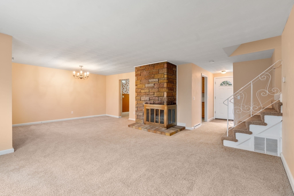 18 Royce Road Framingham, MA 01701 - Photo 2 of 30 a view of an empty room with stairs