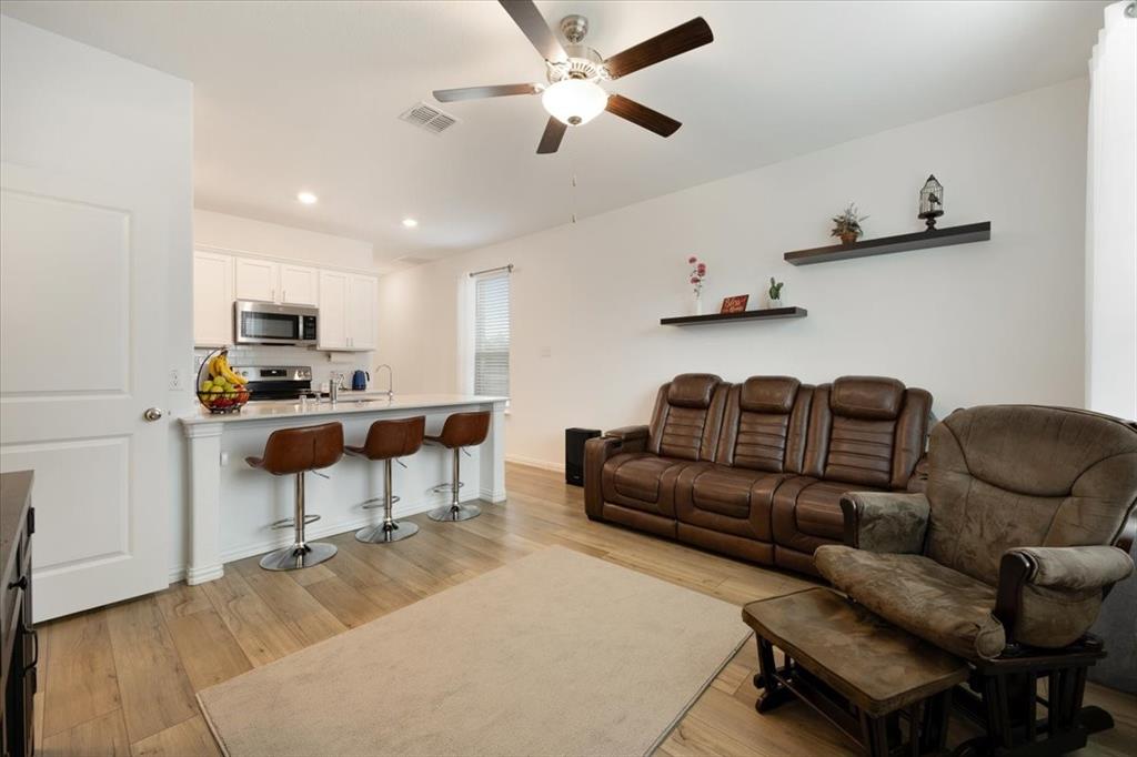 528 Poplar Street Princeton, TX 75407 - Photo 12 of 39 a living room with furniture and a flat screen tv