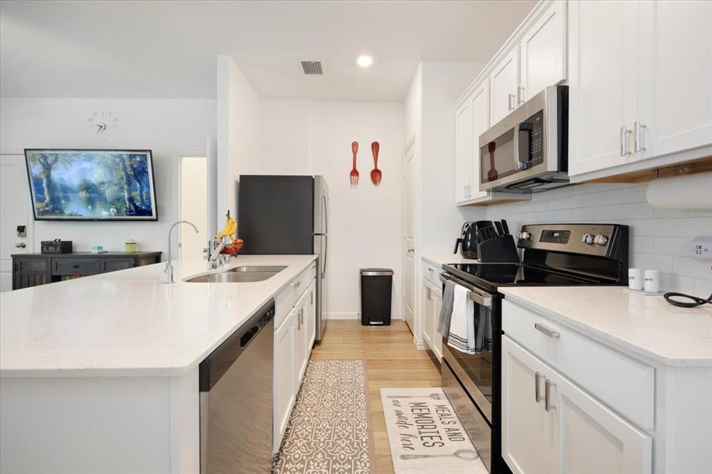 528 Poplar Street Princeton, TX 75407 - Photo 14 of 39 a kitchen with stainless steel appliances a stove refrigerator sink and microwave