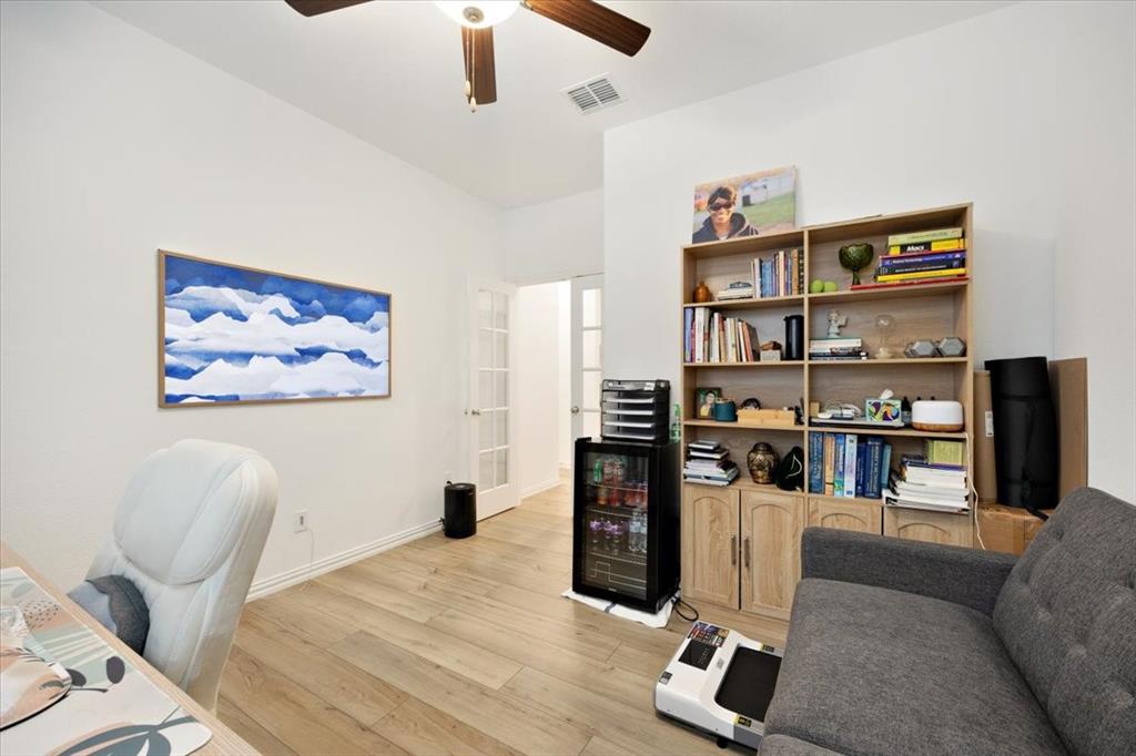 528 Poplar Street Princeton, TX 75407 - Photo 20 of 39 a living room with furniture a rug and a bookshelf