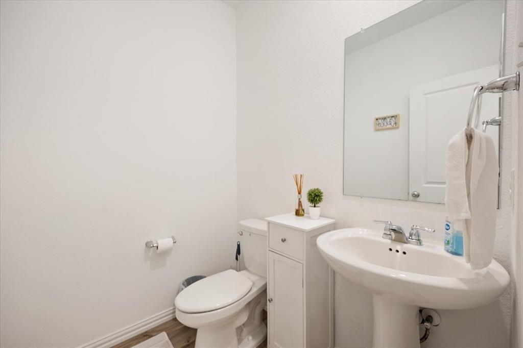 528 Poplar Street Princeton, TX 75407 - Photo 21 of 39 a bathroom with a sink toilet and a mirror