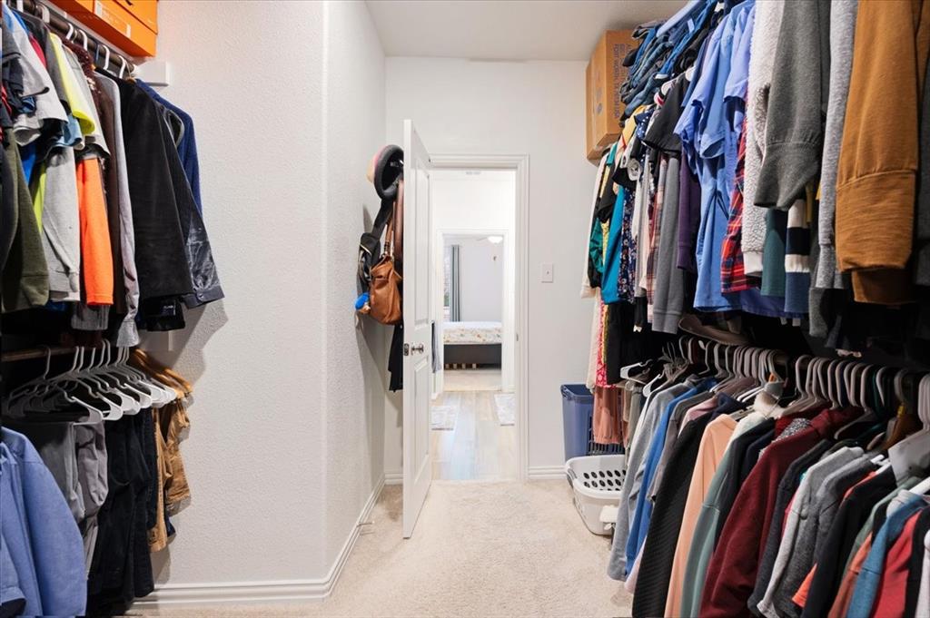 528 Poplar Street Princeton, TX 75407 - Photo 23 of 39 a view of walk in closet with clothes and shoes