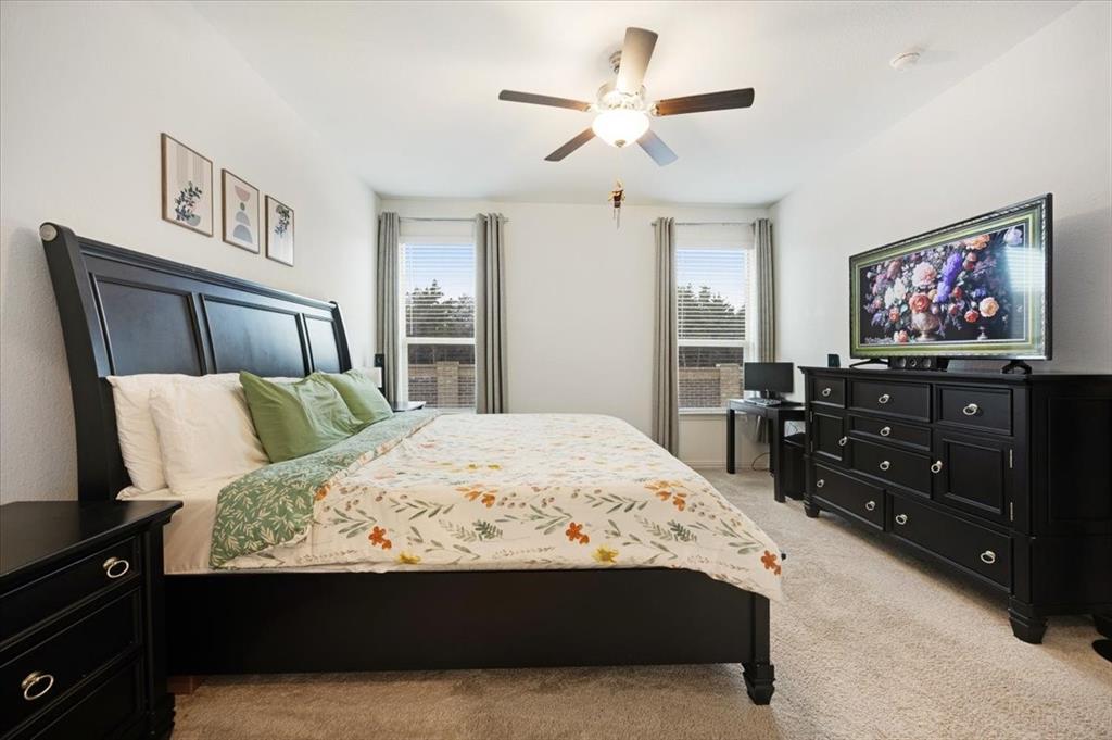 528 Poplar Street Princeton, TX 75407 - Photo 26 of 39 a bed room with a bed and a flat screen tv