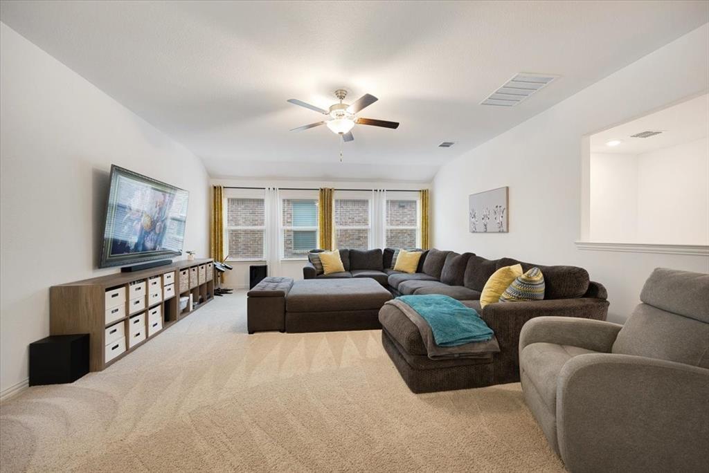 528 Poplar Street Princeton, TX 75407 - Photo 30 of 39 a living room with furniture and a flat screen tv