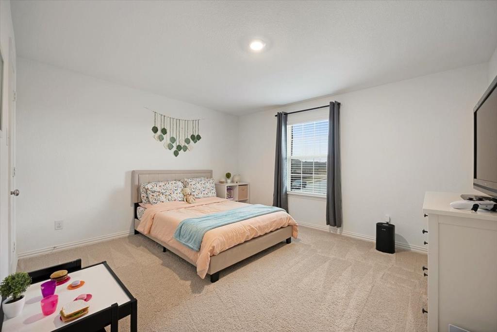 528 Poplar Street Princeton, TX 75407 - Photo 34 of 39 a bedroom with a bed and a window