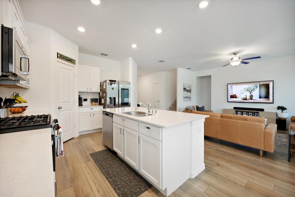 528 Poplar Street Princeton, TX 75407 - Photo 7 of 39 a kitchen with stainless steel appliances granite countertop a sink stove and refrigerator
