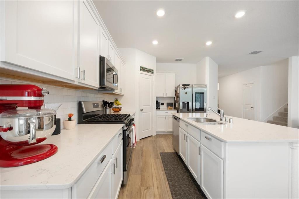 528 Poplar Street Princeton, TX 75407 - Photo 8 of 39 a kitchen with a sink stove and cabinets
