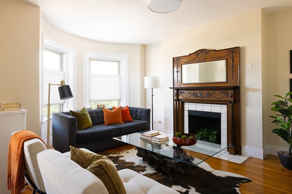 152 Harvard Street, Unit 4 Brookline, MA 02446 - Photo 2 of 26 a living room with furniture and a fireplace