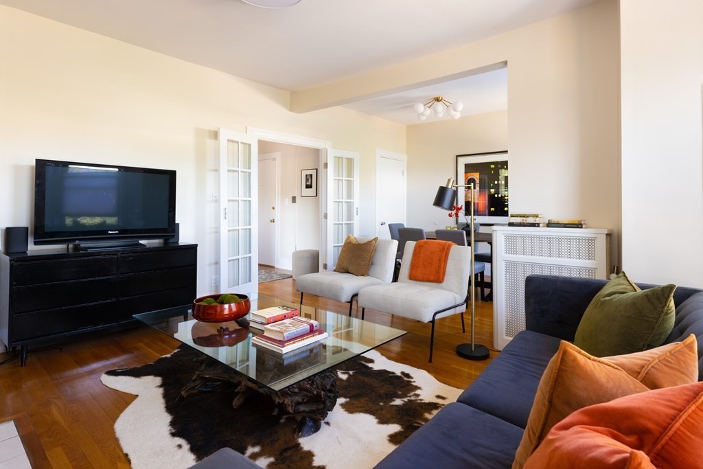152 Harvard Street, Unit 4 Brookline, MA 02446 - Photo 3 of 26 a living room with furniture and a flat screen tv