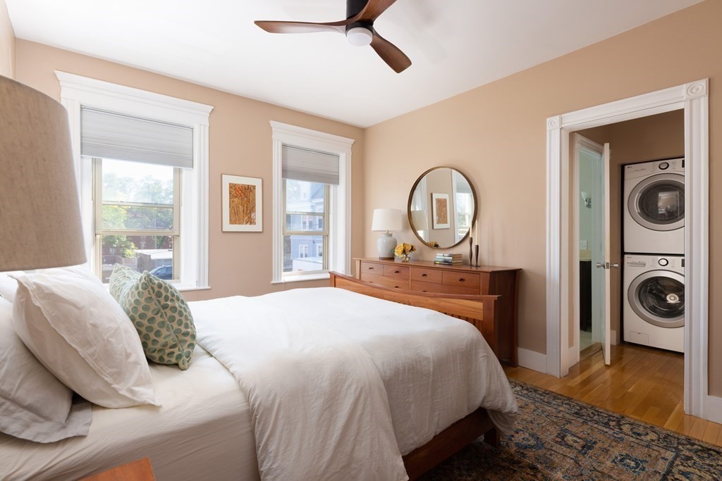 152 Harvard Street, Unit 4 Brookline, MA 02446 - Photo 10 of 26 a bedroom with a bed and a mirror on the dresser