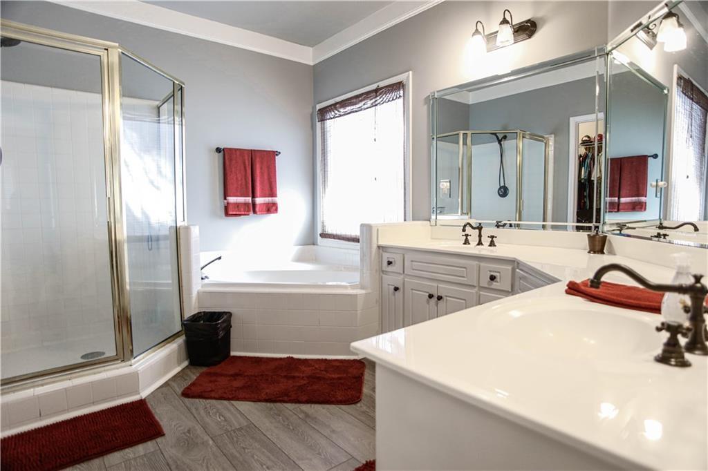 3875 Spring Manor Court Loganville, GA 30052 - Photo 20 of 23 a bathroom with a tub sink and mirror