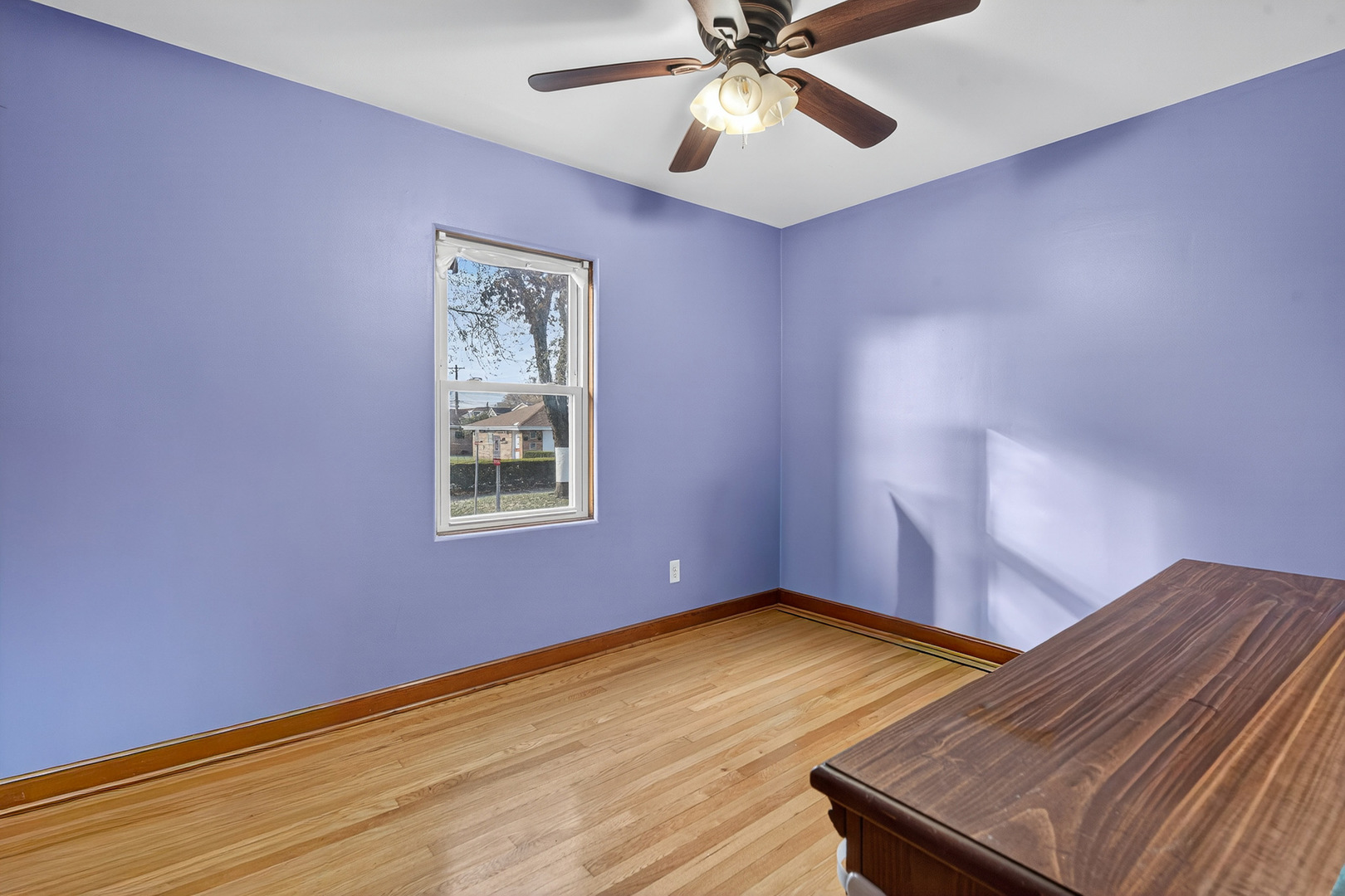 7346 57th Place Summit, IL 60501 - Photo 11 of 29 a view of an empty room with window and wooden floor
