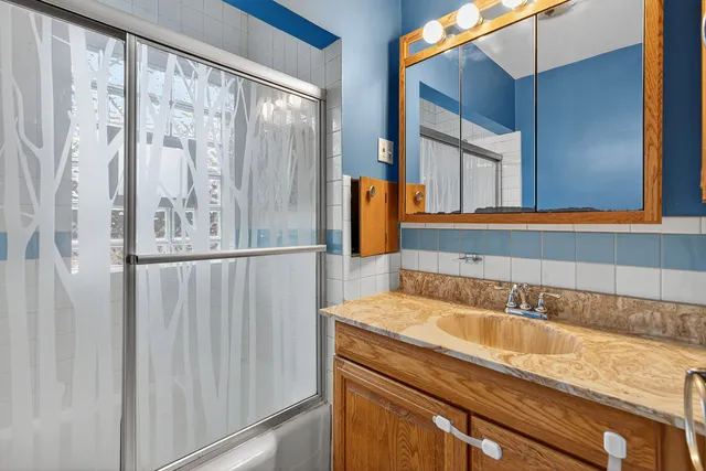 a bathroom with a sink and a mirror