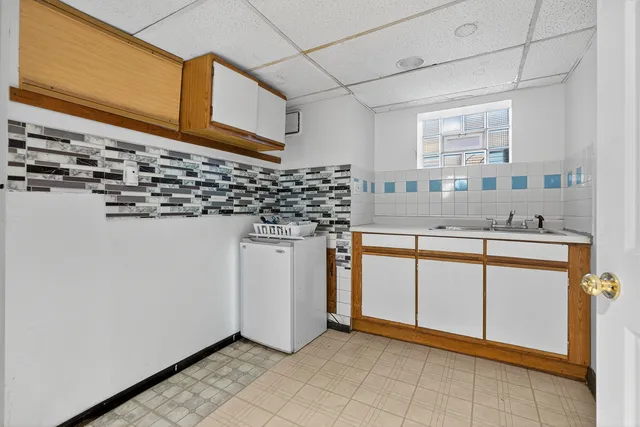 a kitchen with stainless steel appliances a sink and a refrigerator