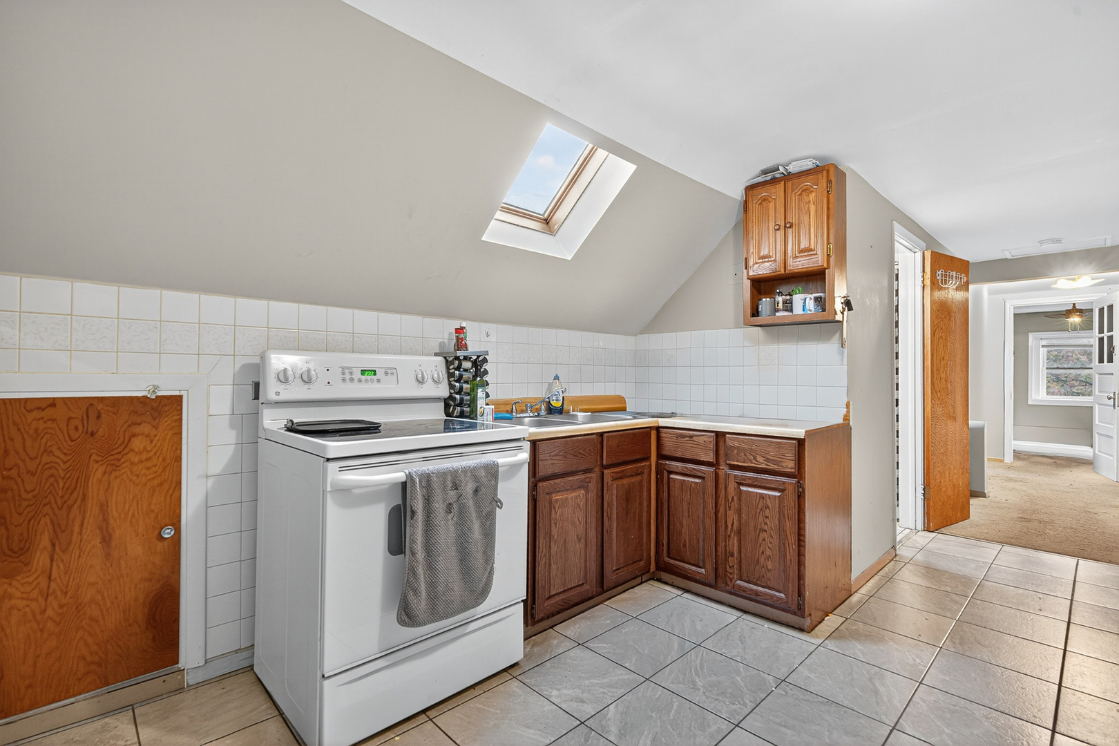 7346 57th Place Summit, IL 60501 - Photo 19 of 29 a kitchen with cabinets and window