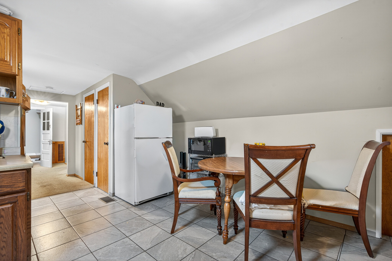 7346 57th Place Summit, IL 60501 - Photo 20 of 29 a dining room with furniture and a refrigerator