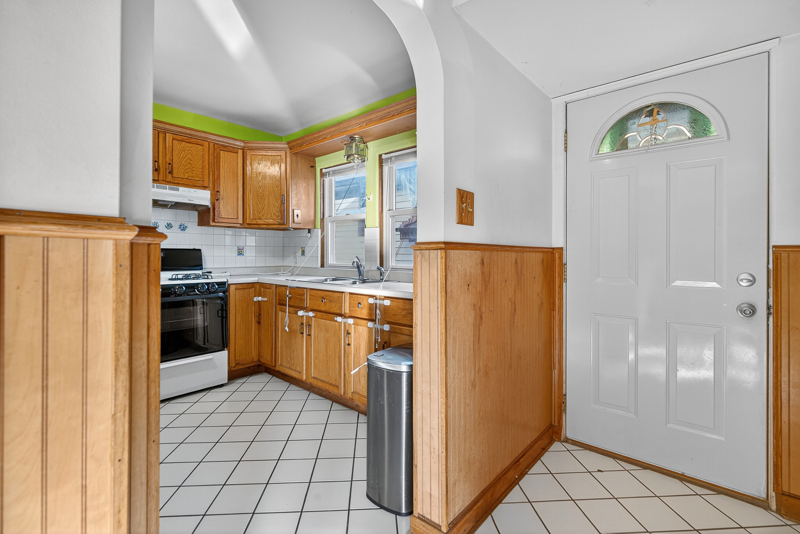 7346 57th Place Summit, IL 60501 - Photo 3 of 29 a kitchen with a refrigerator a sink and a stove top oven